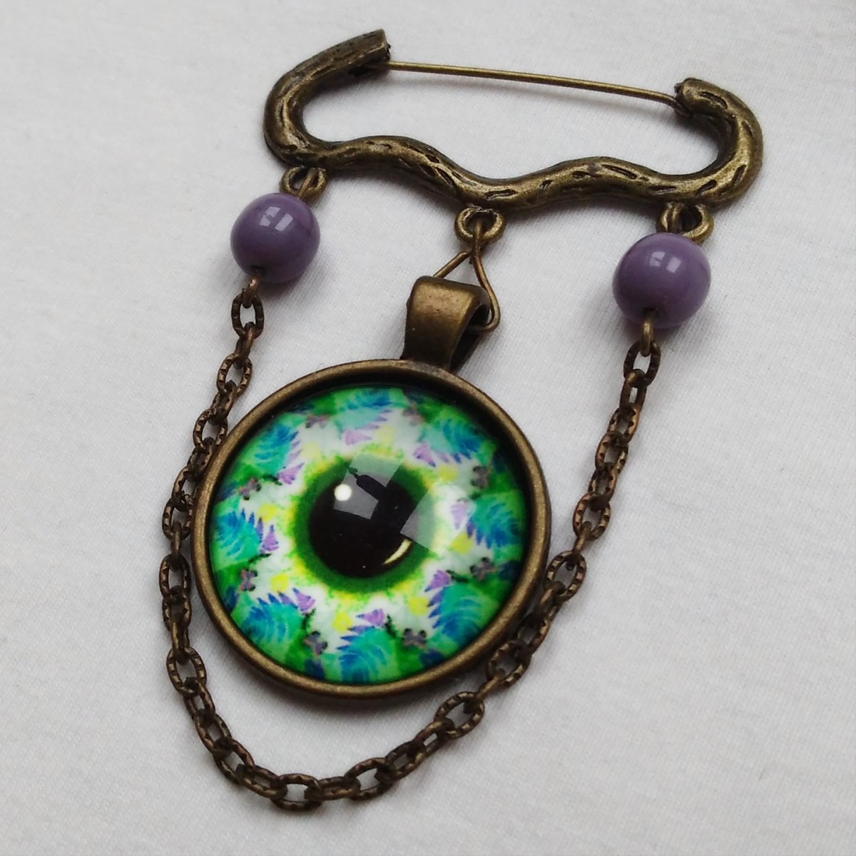 Ozdobný spínací špendlík, magické oko